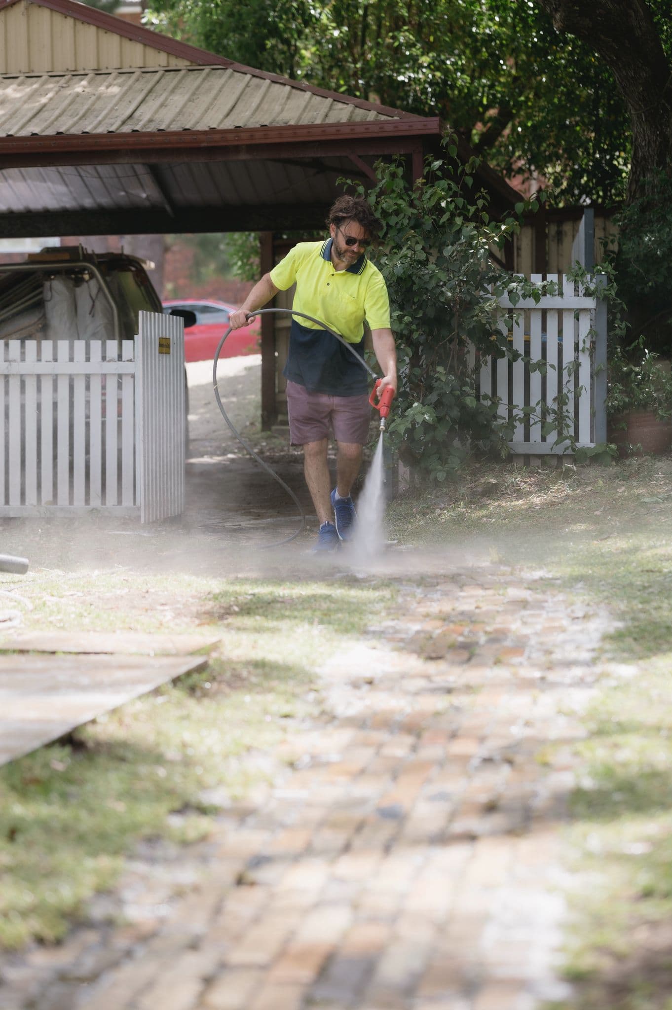 Washlord operator soft-washing a Northern Beaches home exterior