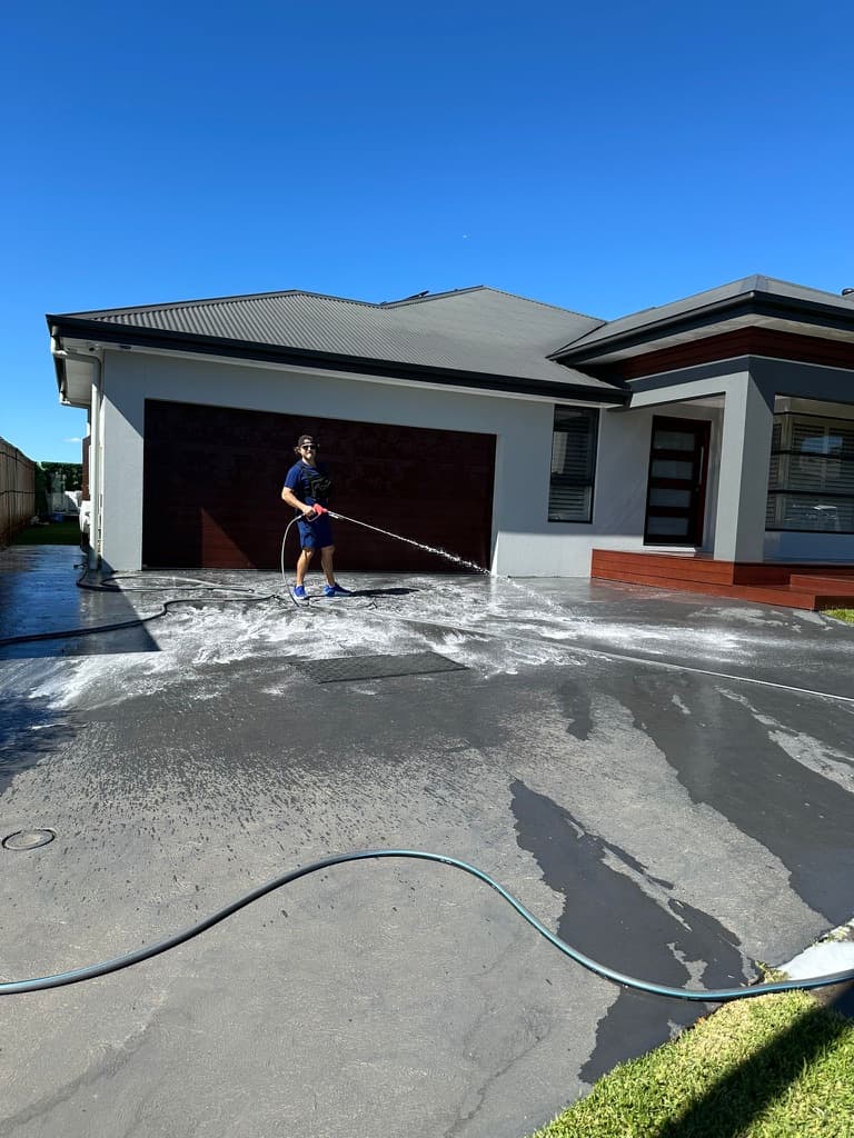 Washlord crew soft-washing a driveway